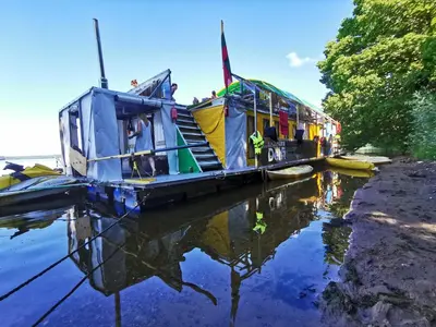 a boat with people on it sitting on the water at Nemo Keliones in Druskininkai