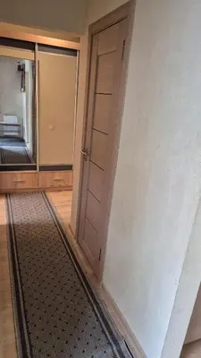 an empty room with a door and a mirror at Apartamentai Zibutės in Kaunas
