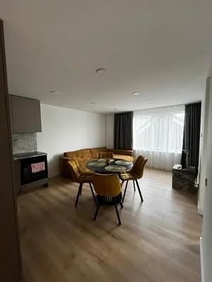 a living room with a table and chairs and a couch at Girios Horizontas - Mara in Trakai