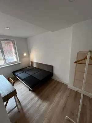 a bedroom with a bed in the corner of a room at Girios Horizontas - Mara in Trakai