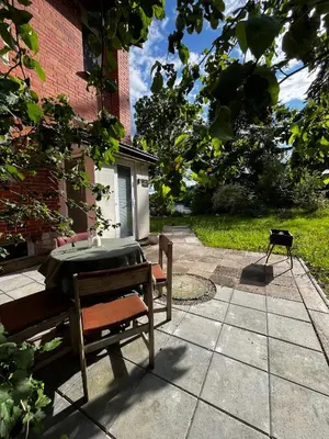 a patio with a table and a bench next to a building at Girios Horizontas - Mara in Trakai