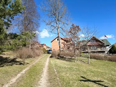 a dirt road in front of a house at Girios Horizontas - Mara in Trakai