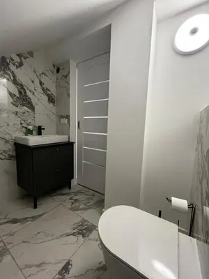 a white bathroom with a sink and a toilet at Girios Horizontas - Mara in Trakai