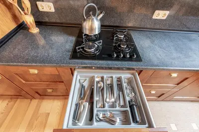 a kitchen sink with utensils in a drawer at Prestige Vilnius Old Town Apartment by Reside Baltic in Vilnius