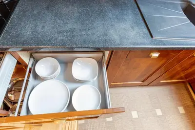 a drawer with white dishes in a kitchen at Prestige Vilnius Old Town Apartment by Reside Baltic in Vilnius