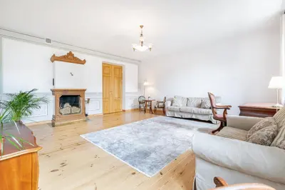 a living room with a couch and a fireplace at Prestige Vilnius Old Town Apartment by Reside Baltic in Vilnius
