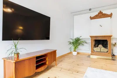 a living room with a large flat screen tv on a wall at Prestige Vilnius Old Town Apartment by Reside Baltic in Vilnius