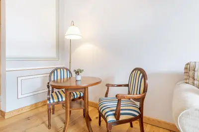 a room with two chairs and a table and a bed at Prestige Vilnius Old Town Apartment by Reside Baltic in Vilnius