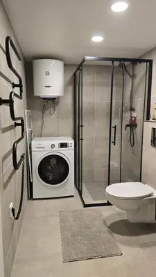 a bathroom with a washing machine and a toilet at BlueLoft Kaunas in Kaunas