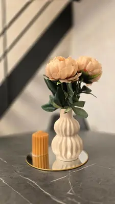 a vase with two roses in it on a table at BlueLoft Kaunas in Kaunas