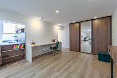 an office with a desk and a chair in a room at Symphony Apartment with free parking in Kaunas