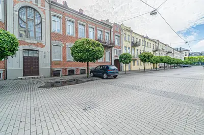 a car parked on a street in front of buildings at Symphony Apartment with free parking in Kaunas