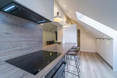 a kitchen with a counter top and some stools at Symphony Apartment with free parking in Kaunas