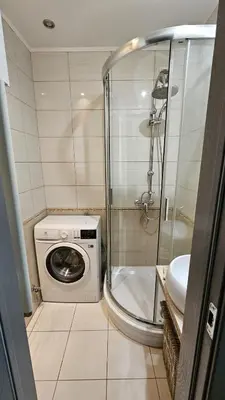 a bathroom with a washing machine and a shower at Jaukus butas Zarasu centre in Zarasai