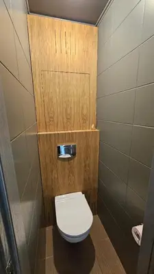 a small bathroom with a toilet in a stall at Jaukus butas Zarasu centre in Zarasai