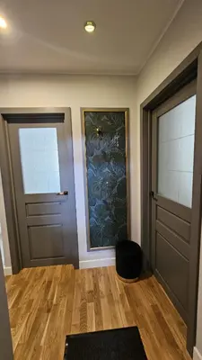 a room with two doors and a wooden floor at Jaukus butas Zarasu centre in Zarasai