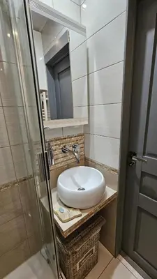 a bathroom with a white sink and a mirror at Jaukus butas Zarasu centre in Zarasai