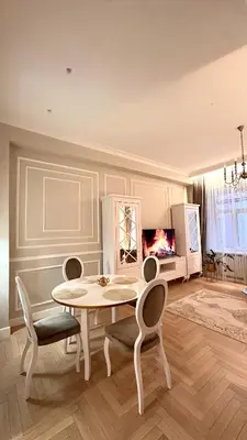 a dining room with a table and chairs and a television at Old Town Residence Kaunas in Kaunas