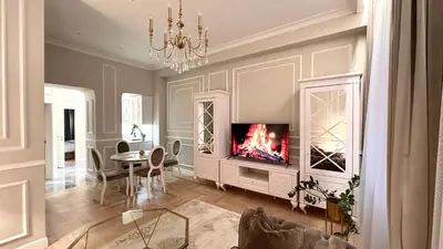a living room with a fireplace and a dining room at Old Town Residence Kaunas in Kaunas