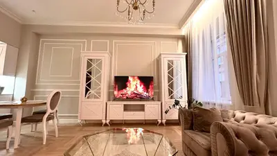 a living room with a couch and a tv at Old Town Residence Kaunas in Kaunas