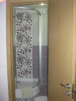 a bathroom with a shower and a toilet in a room at Apartamentai Atostogos in Druskininkai