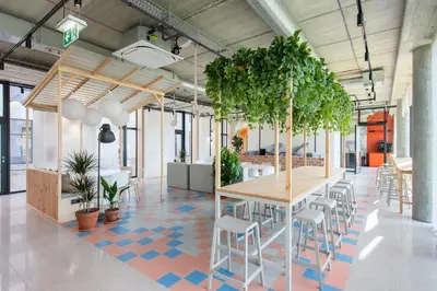 a room with a table and chairs and plants at SHED Coliving studio in Vilnius