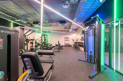 a gym with treadmills and exercise bikes in it at SHED Coliving studio in Vilnius