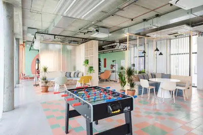 an office with a foosball table in the middle of a room at SHED Coliving studio in Vilnius