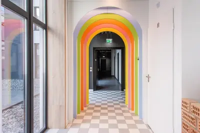 a hallway with a rainbow painted on the wall at SHED Coliving studio in Vilnius