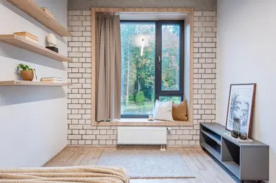 a living room with a window and a radiator at SHED Coliving studio in Vilnius