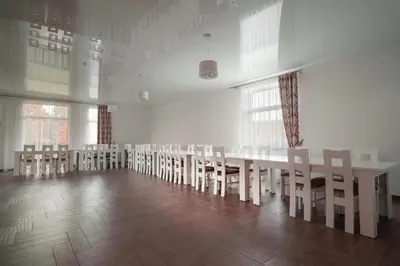 a room with a long table and chairs at Vėjo Malūnų sodyba - Didžioji vila in Paserninkai