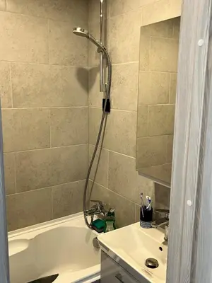 a bathroom with a shower and a tub and a sink at Very quiet and cozy place in Vilnius