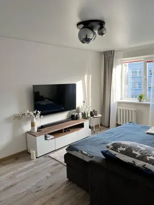 a bedroom with a bed and a flat screen tv at Very quiet and cozy place in Vilnius
