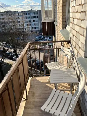 two white chairs sitting on a balcony with a view at Very quiet and cozy place in Vilnius