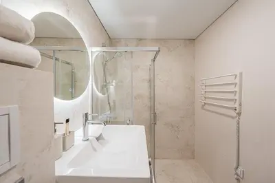 a bathroom with a shower and a sink and a tub at GOOD LOCATION studio near the old town - station - airport - self check in in Vilnius