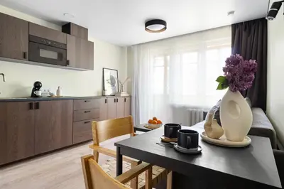 a kitchen and dining room with a table and chairs at GOOD LOCATION studio near the old town - station - airport - self check in in Vilnius