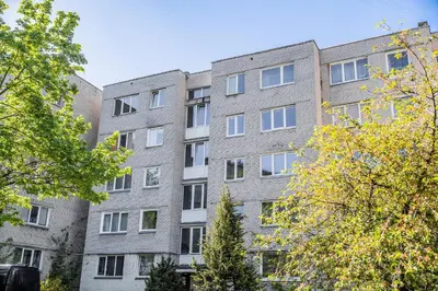 an apartment building with trees in front of it at GOOD LOCATION studio near the old town - station - airport - self check in in Vilnius