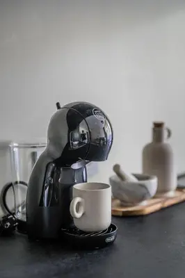 a coffee maker sitting on a counter with a cup at GOOD LOCATION studio near the old town - station - airport - self check in in Vilnius