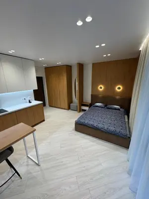 a large room with a bed and a kitchen at V4 Europa New Apartment in Vilnius