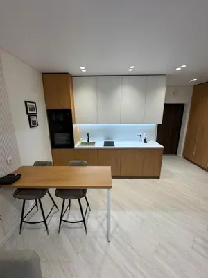 a kitchen with a table and chairs in a room at V4 Europa New Apartment in Vilnius