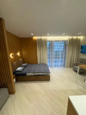 a large bedroom with a bed and a couch at V4 Europa New Apartment in Vilnius