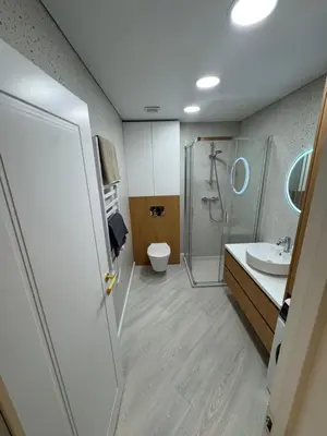 a bathroom with a shower and a toilet and a sink at V4 Europa New Apartment in Vilnius