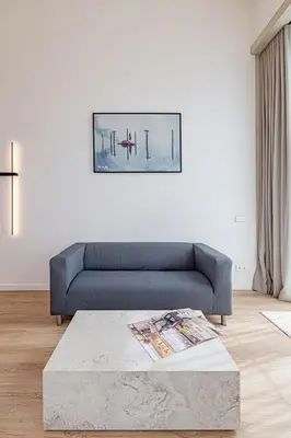 a living room with a blue couch and a table at RADIO CITY Loft 345 by Domvia in Kaunas