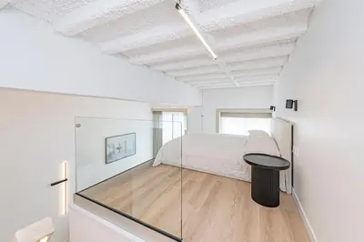 a bedroom with a bed and a glass wall at RADIO CITY Loft 345 by Domvia in Kaunas