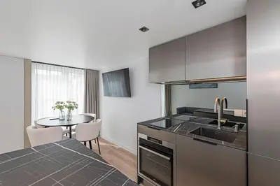 a kitchen with a sink and a table at RADIO CITY Loft 345 by Domvia in Kaunas