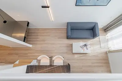 a room with a blue chair and a pair of shoes at RADIO CITY Loft 345 by Domvia in Kaunas