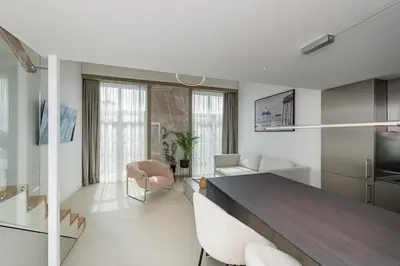 a kitchen and living room with a table and chairs at RADIO CITY Loft 435 by Domvia in Kaunas