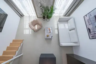 a living room with a staircase and a window at RADIO CITY Loft 435 by Domvia in Kaunas