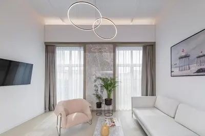 a living room with a couch and a chandelier at RADIO CITY Loft 435 by Domvia in Kaunas