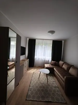 a living room with a couch and a table at Egidijaus apartamentai Panevėžyje in Panevėžys
